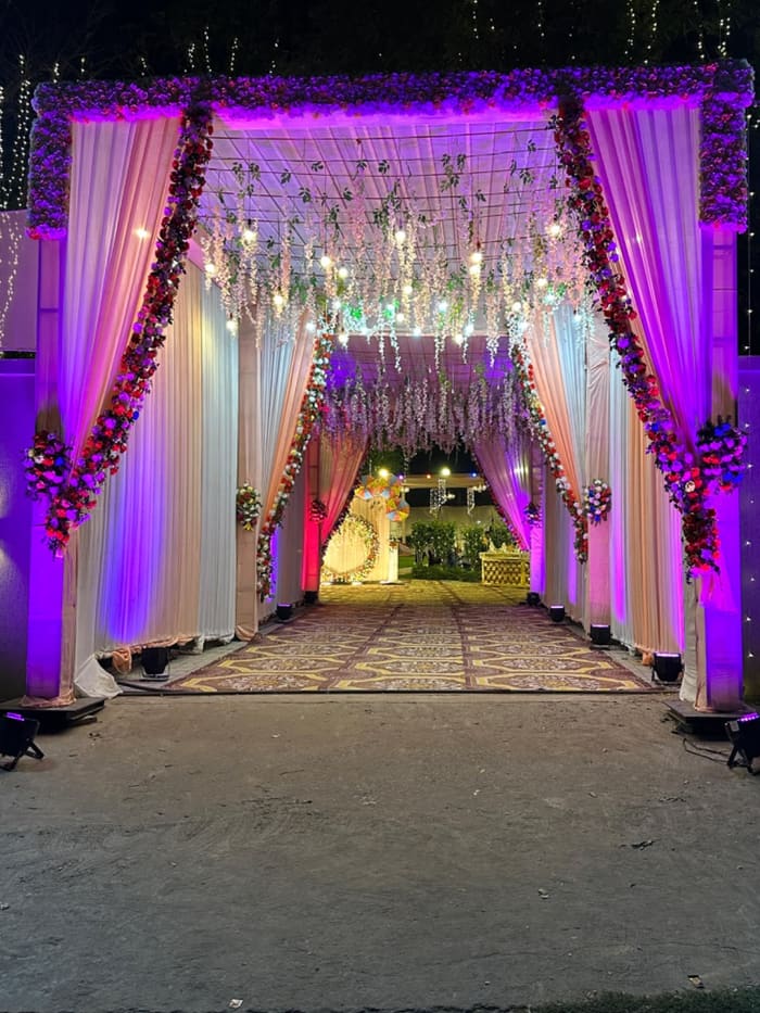 Purple-lit floral entrance gate